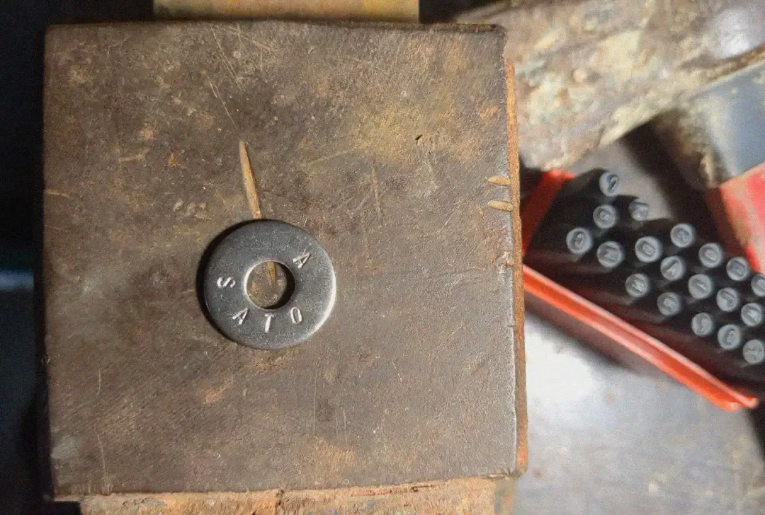 A washer stamped with letters